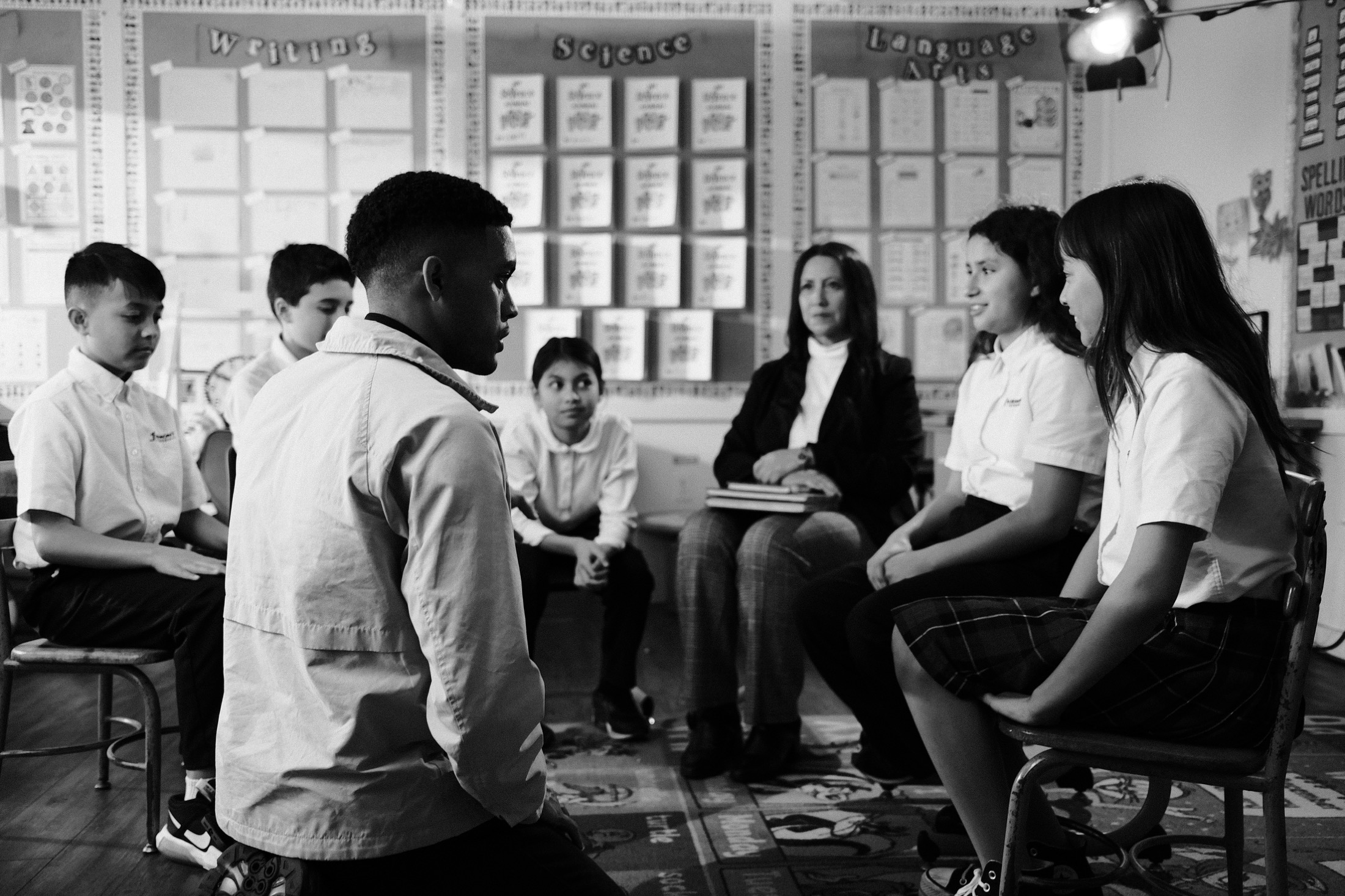 Director working with students and a teacher during a classroom production